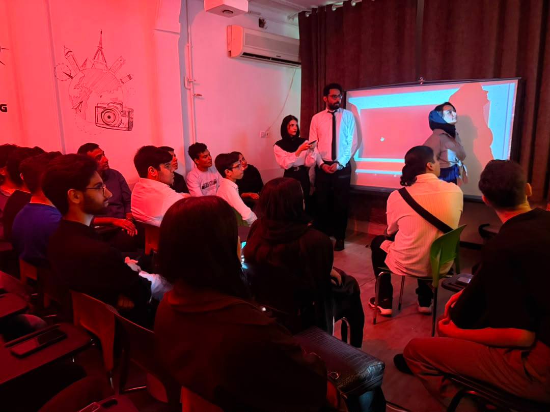 Students in a language class discussing around a table
